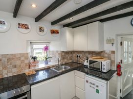 A kitchen with a sink and appliances at 3 Rock Cottages in Kingston