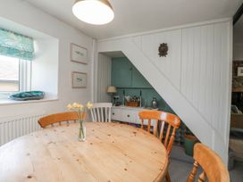 A dining room with a table and chairs at 3 Rock Cottages in Kingston