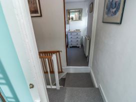 A staircase leading to a room with a nightstand and lamp at 3 Rock Cottages Kingston