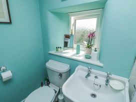 A bathroom with a toilet and sink at 3 Rock Cottages Kingston