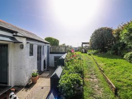 A garden with flowers and a pathway at 3 Rock Cottages in Kingston