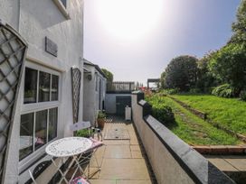 A patio area with a table and chairs at 3 Rock Cottages Kingston