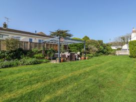 A garden with a gazebo and seating area at 3 Rock Cottages Kingston