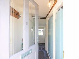 A hallway with hooks and a light fixture at 3 Rock Cottages Kingston