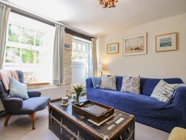 A living room with a sofa and armchair at 3 Rock Cottages Kingston