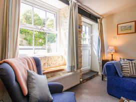 A living room with an armchair and a sofa at 3 Rock Cottages in Kingston