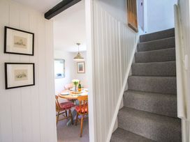 A hallway with a staircase leading to upper floor at 3 Rock Cottages Kingston