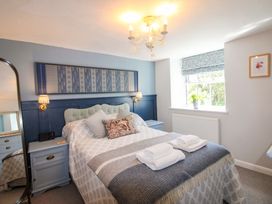 A bedroom with a bed and bedside tables at 3 Rock Cottages in Kingston