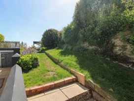 A garden with a pathway and flower bed at 3 Rock Cottages Kingston