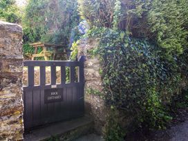 An entrance gate with stone wall and table at 3 Rock Cottages Kingston