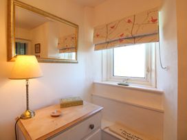 A utility room with a lamp and a window at 3 Rock Cottages Kingston