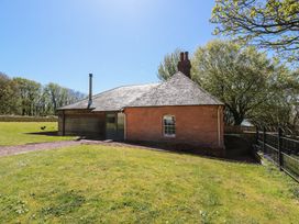 A house with a chimney in an outdoor area at Ardlochan Lodge - Culzean Castle in Maybole