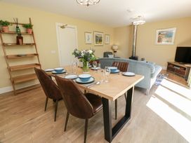 A dining room with a table and chairs at Ardlochan Lodge - Culzean Castle, Maybole