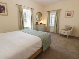 A bedroom with a bed and dresser at Ardlochan Lodge - Culzean Castle, Maybole