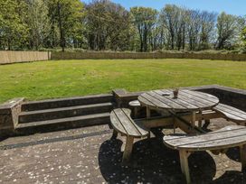 A garden area with a wooden table and benches at Ardlochan Lodge - Culzean Castle in Maybole