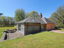 An outdoor area with a house and seating at Ardlochan Lodge - Culzean Castle Maybole