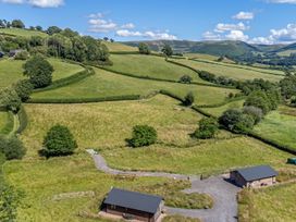 A view of fields and trees at Birch Banc Retreats - Bedw Llanidloes