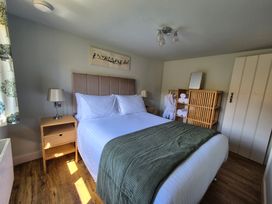 A bedroom with a bed and shelves at Birch Banc Retreats - Bedw Llanidloes