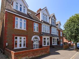 A building with multiple windows and a sign at Maples in Hunstanton