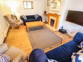 A living room with a coffee table and fireplace at Maples in Hunstanton