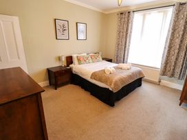 A bedroom with a bed and bedside table at Maples in Hunstanton