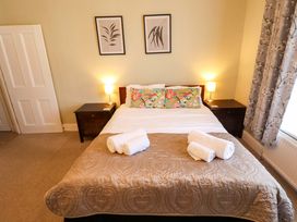 A bedroom with a bed and bedside tables at Maples in Hunstanton