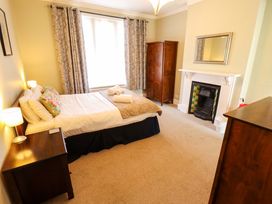 A bedroom with a bed and wardrobe at Maples in Hunstanton