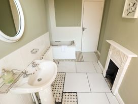 A bathroom with a bathtub and sink at Maples in Hunstanton