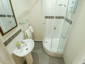 A bathroom featuring a shower, sink, and mirror at Maples in Hunstanton