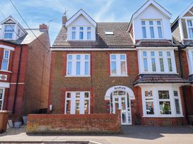 A house with multiple windows and a door at Maples in Hunstanton