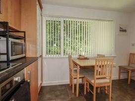 A kitchen with a table and chairs at 49 Atlantic Reach in Newquay