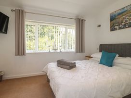A bedroom with a bed and television at 49 Atlantic Reach in Newquay