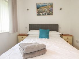 A bedroom with a bed and towels on it at 49 Atlantic Reach in Newquay