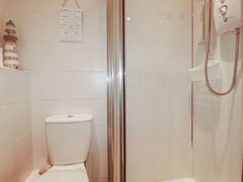 A bathroom with a shower and toilet at 49 Atlantic Reach in Newquay