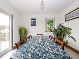 A dining room with a long table and chairs at Sherriff, Troutbeck, near Keswick