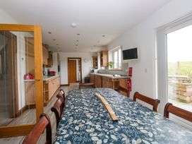 A kitchen with a dining table and cabinets at Sherriff, Troutbeck, near Keswick
