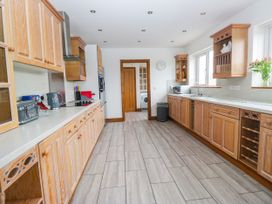 A kitchen with wooden cabinets and appliances at Sherriff, Troutbeck, near Keswick