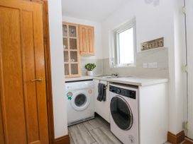A laundry room with a washing machine and sink at Sherriff, Troutbeck, near Keswick