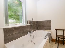A bathroom with a bathtub and a window at Sherriff, Troutbeck, near Keswick