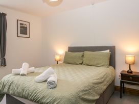 A bedroom with a bed and bedside lamps at Sherriff in Troutbeck, near Keswick