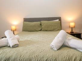 A bedroom with a bed and towels at Sherriff in Troutbeck, near Keswick