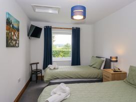 A bedroom with two single beds and a television at Sherriff in Troutbeck, near Keswick