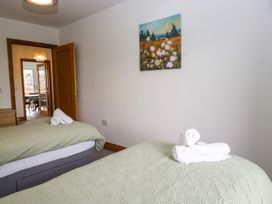 A bedroom with two beds and towels at Sherriff, Troutbeck, near Keswick