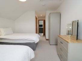 A bedroom with two beds and storage furniture at Sherriff, Troutbeck, near Keswick