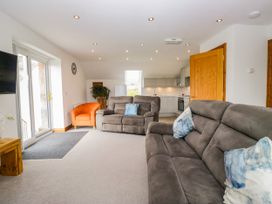 A living room with sofas and an armchair at Sherriff, Troutbeck near Keswick