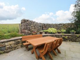 A garden with a wooden table and chairs at Sherriff, Troutbeck, near Keswick
