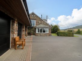 A house with a garage and bench in the outdoor area at Sherriff, Troutbeck, near Keswick