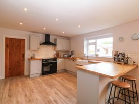 A kitchen with cabinets and countertop at Afallon in Llanbedrog