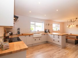 A kitchen with wooden counters and a coffee machine at Afallon in Llanbedrog