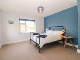 A bedroom with a bed and table at Afallon in Llanbedrog